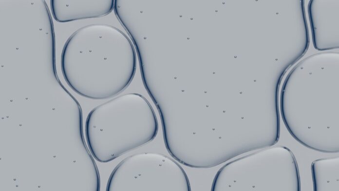 Abstract pattern of liquid bubbles with small particles.