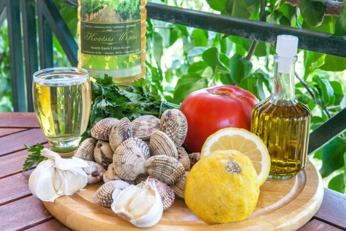 a plate of food and a bottle of wine on a table